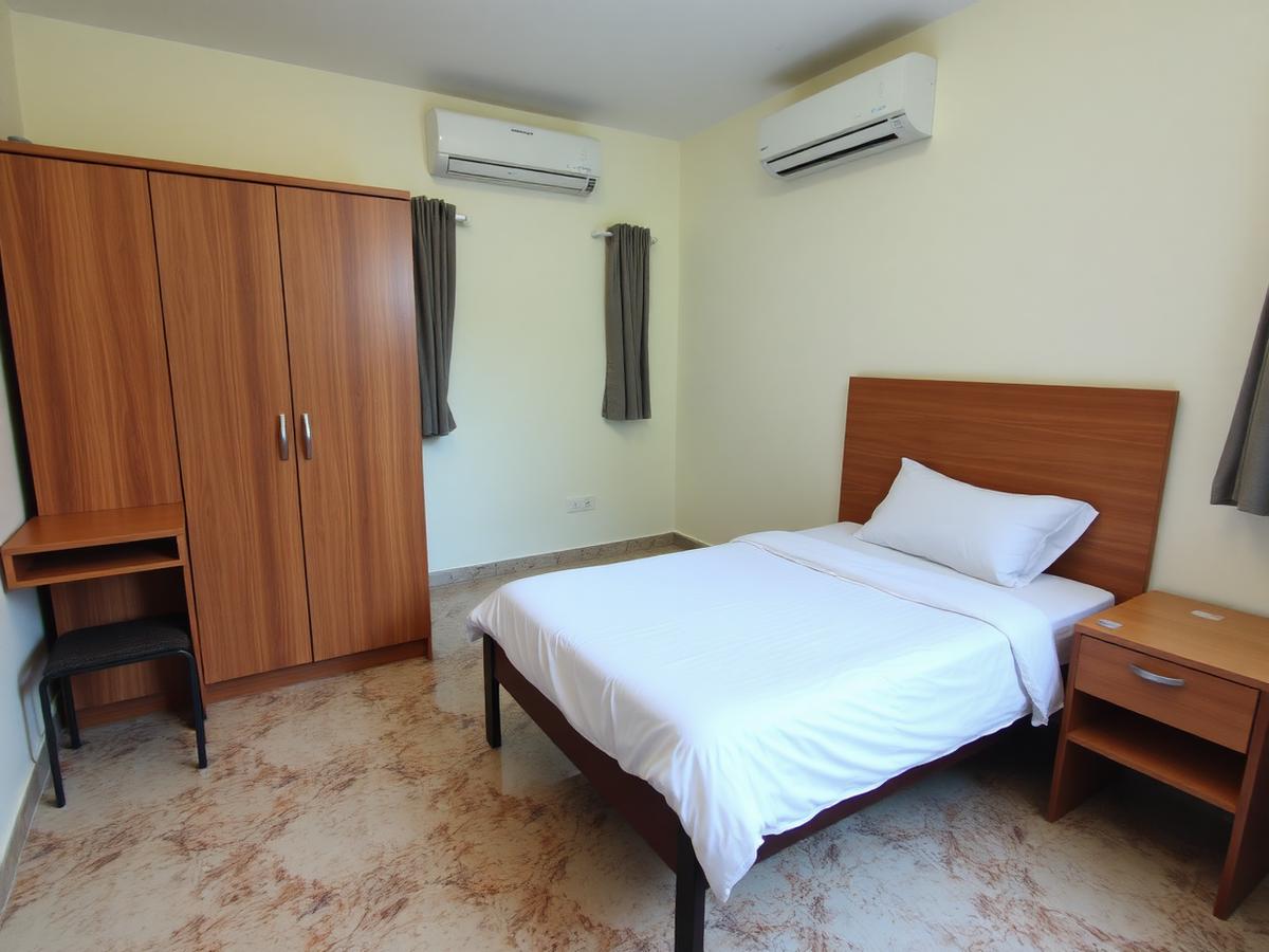 Kamar kost dengan ranjang, meja belajar, lemari, dan AC